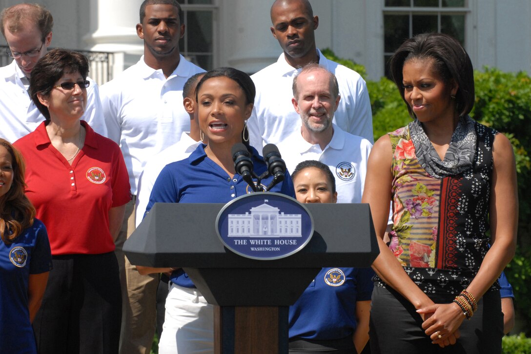 Olympic gold medalist Dominique Dawes introduces First Lady Michelle Obama during a fitness and nutrition event on the White House's South Lawn, May 9, 2011. The first lady announced new Let’s Move commitments specifically designed for military kids and families. 