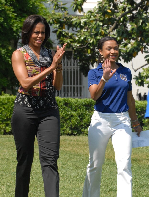 First Lady Michelle Obama and Olympic gold medalist Dominique Dawes support partitipants at the fitness and nutrition event on the White House's South Lawn, May 9, 2011.