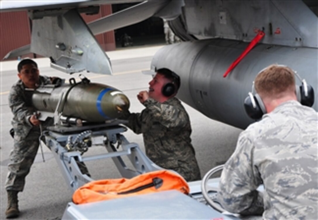 U.S. Air Force airmen take part in a quarterly weapons load crew competition at Osan Air Base, South Korea, on May 6, 2011.  A team from the 25th Aircraft Maintenance Unit, 36th Aircraft Maintenance Unit and 354th Expeditionary Fighter Squadron loaded a Mark 82 general purpose bomb, a CBU-87 air delivered cluster weapon system and an AIM-9 Sidewinder air-to-air missile during the timed portion of the event.  