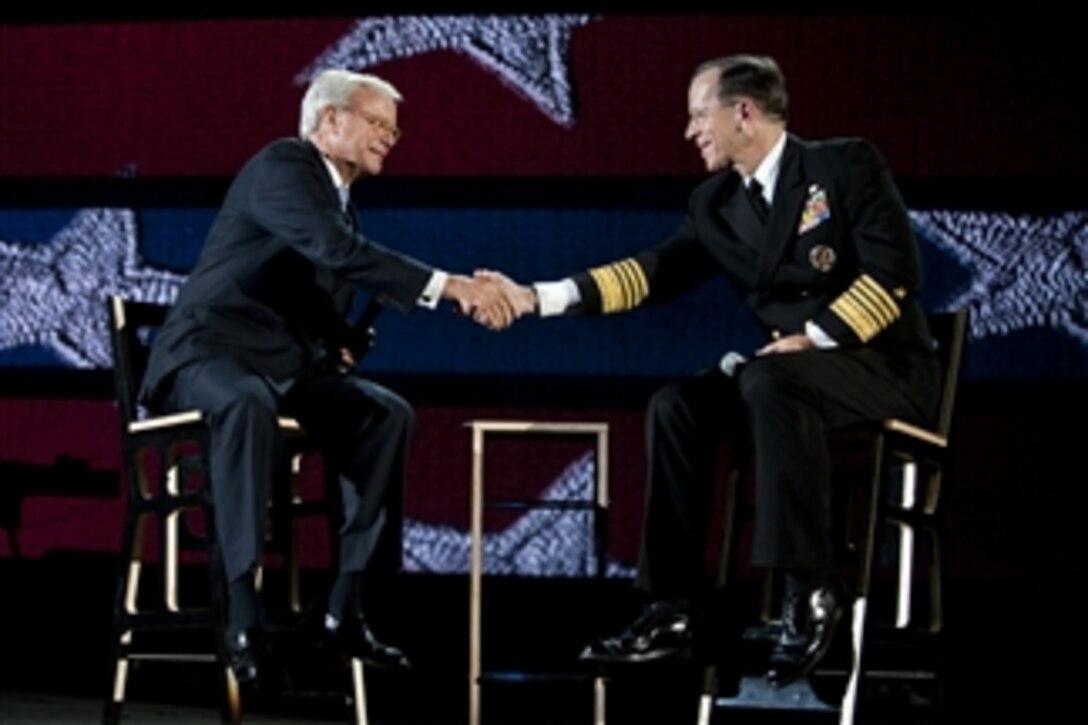 Chairman of the Joint Chiefs of Staff Adm. Mike Mullen, U.S. Navy, thanks Tom Brokaw after appearing at the 2011 Robin Hood Foundation Gala in New York City on May 9, 2011.  Robin Hood has targeted poverty in New York City by supporting and developing organizations that provide direct services to poor New Yorkers.  