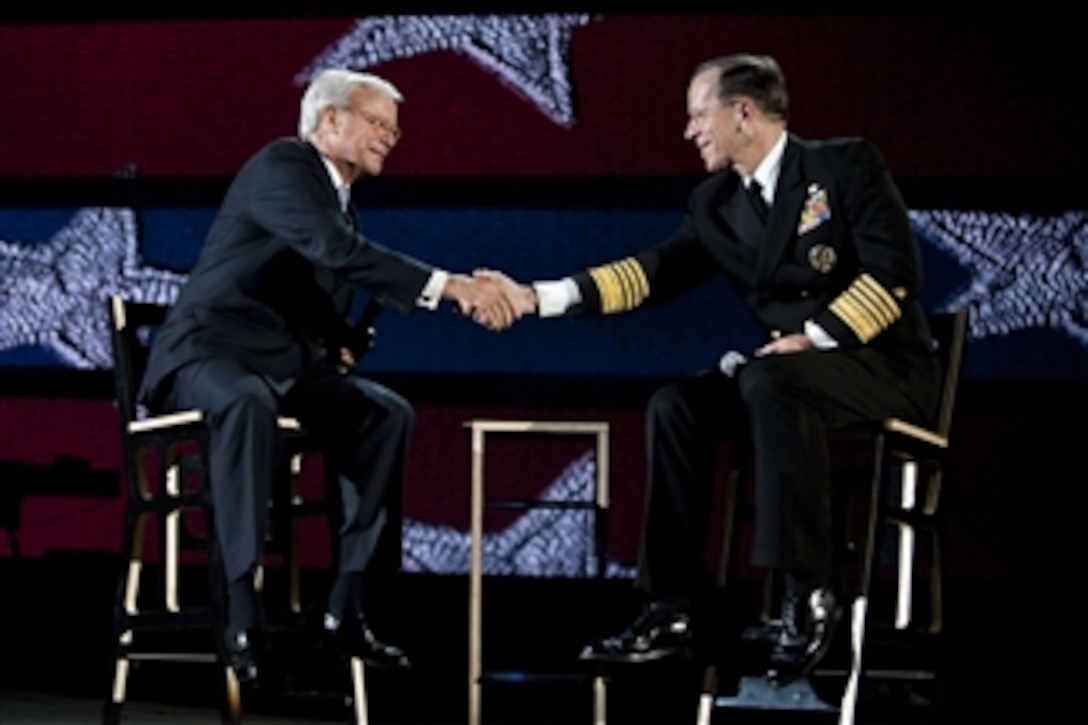 Chairman of the Joint Chiefs of Staff Adm. Mike Mullen, U.S. Navy, thanks Tom Brokaw after appearing at the 2011 Robin Hood Foundation Gala in New York City on May 9, 2011.  Robin Hood has targeted poverty in New York City by supporting and developing organizations that provide direct services to poor New Yorkers.  