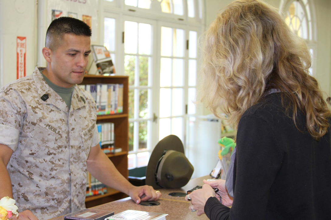 Master Sgt. Frank Puebla, Support Battalion, learns how to use a play away audio book from technician Melissa Hansen. "The audio books really help on the long commute to Oceanside, especially with all the traffic," said Puebla.