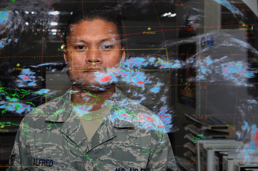 Staff Sgt. Paul Alfred, 36th Operations Support Squadron weather forecaster, poses in front of a thermal infrared satellite feed of the Pacific Region here May 11. Sergeant Alfred was recently awarded 2010’s Weather Noncommissioned Officer of the Year at the Air Force level for showing outstanding initiative and leadership ability. (U.S. Air Force photo/Senior Airman Carlin Leslie) 