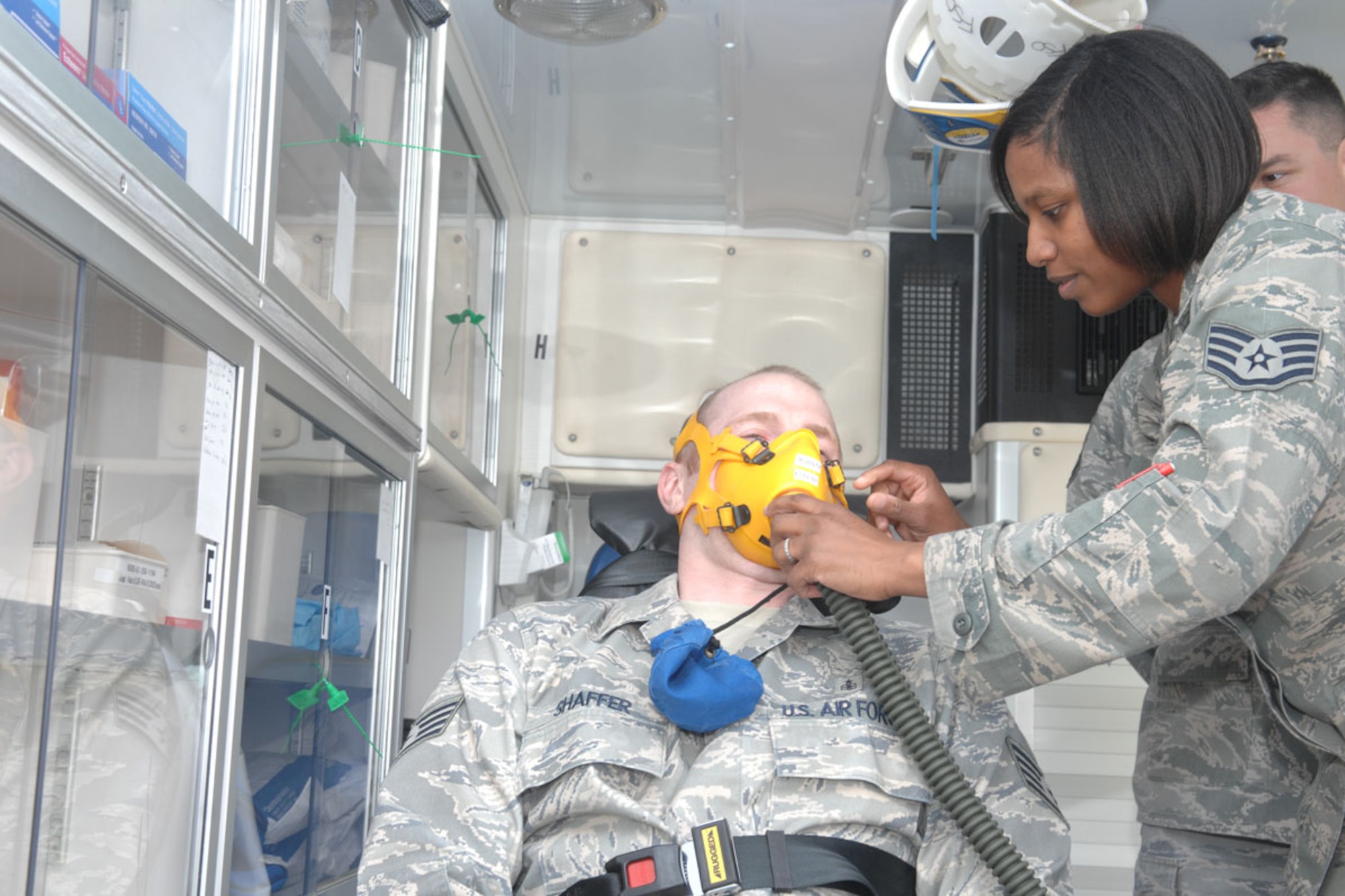 Air Force Staff Sgt. Alexis Lewis, 673d Aerospace Medicine Squadron independent duty medical technician, practices placing an oxygen mask on a patient. (U.S. Air Force photo/SSgt Jeremy Larlee)