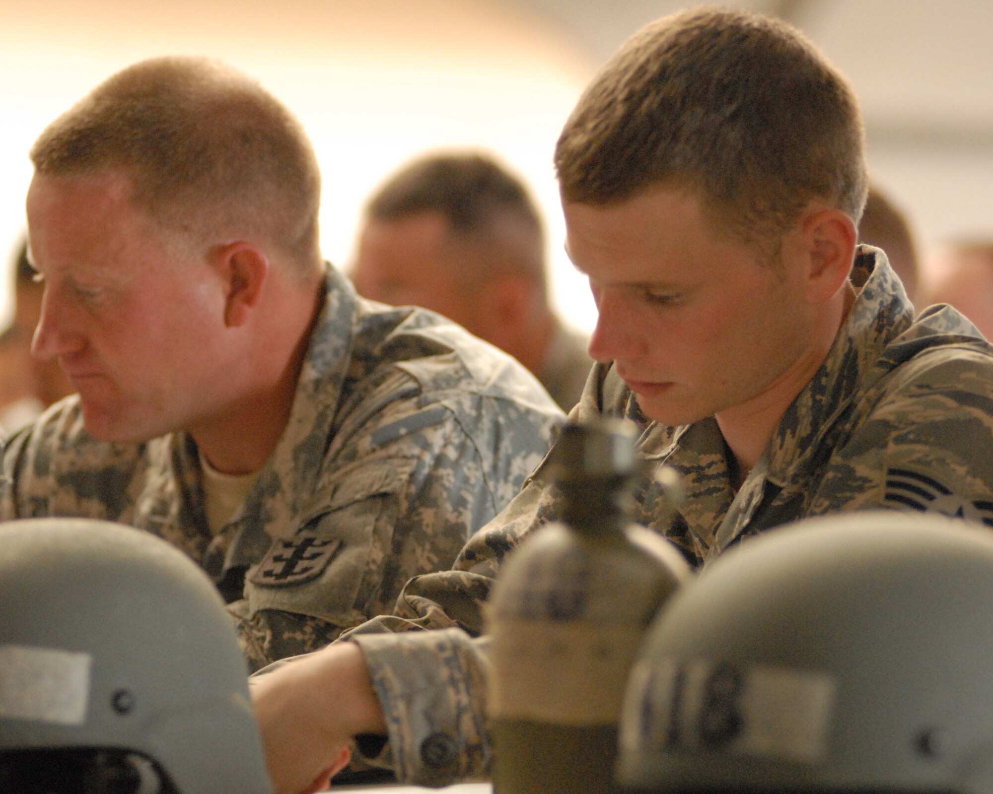 Senior Airman Jordan Miller studies Air Assault Course curriculum with fellow Airmen and Soldiers May 10, 2011, in Wahiawa, Hawaii. He and four other 647th Security Forces Squadron Airmen were chosen to participate with 309 Soldiers in an 11-day Army Air Assault course April 30 to May 11, 2011. (U.S. Air Force photo/Staff Sgt. Carolyn Herrick) 

