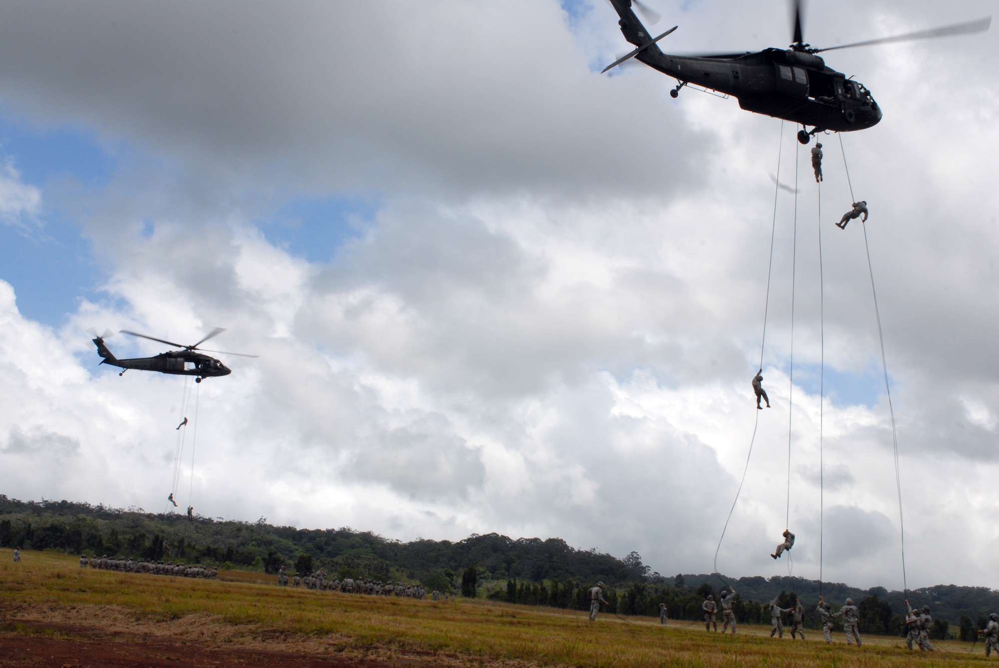 Airmen and Soldiers rappel out of a UH-60 Blackhawk May 10, 2011, in Wahiawa, Hawaii. Five 647th Security Forces Squadron Airmen were chosen to participate with 309 Soldiers in an 11-day Army Air Assault course April 30 to May 11, 2011. (U.S. Air Force photo/Staff Sgt. Carolyn Herrick) 
