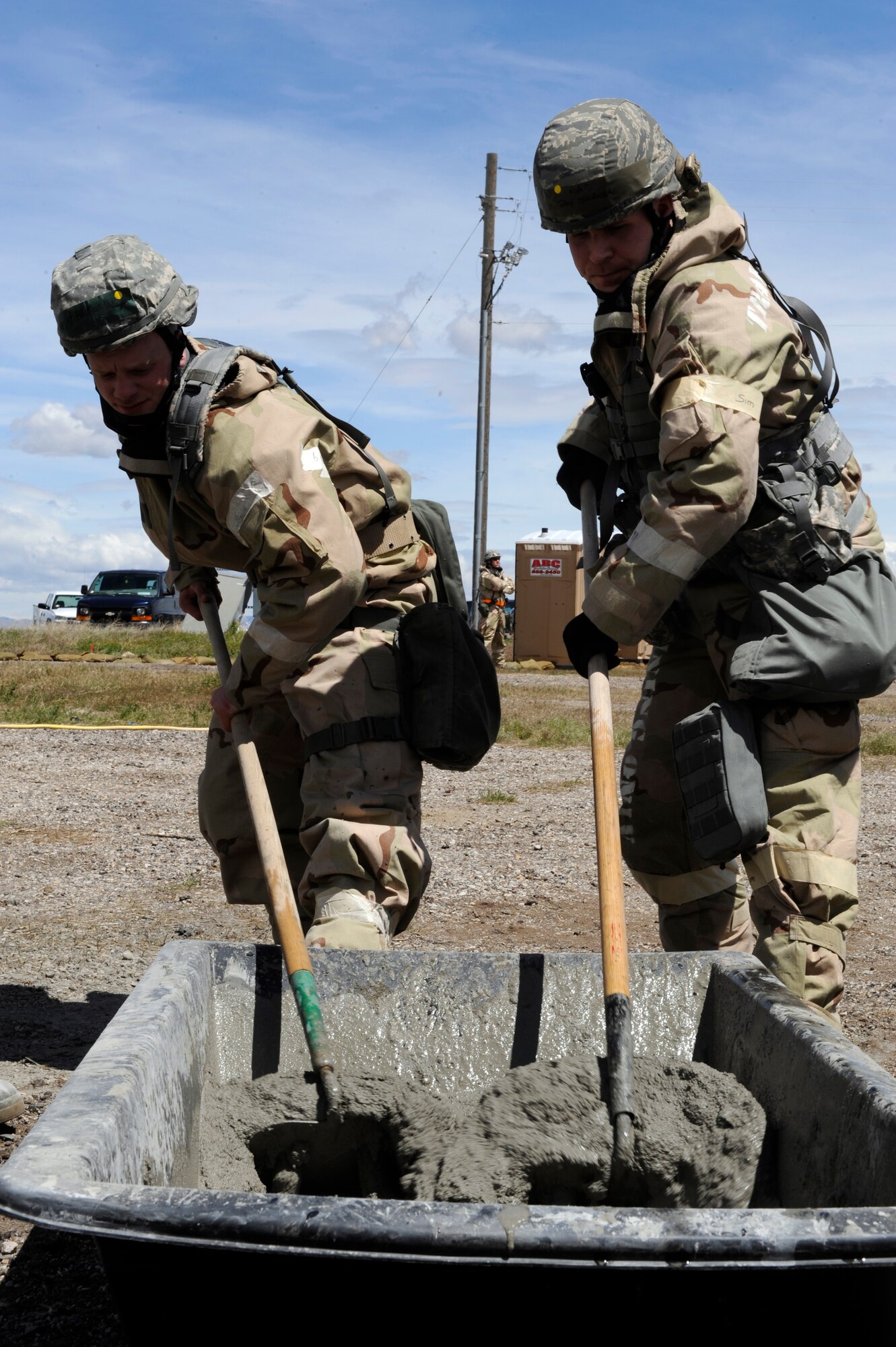 MOUNTAIN HOME AIR FORCE BASE, Idaho – Airman 1st Class Mark Anderson and Technical Sergeant John Jockusch, 366th Civil Engineer Squadron, mix the grout used to meld cinder blocks together that will be used for a building foundation May 10. The structure is being constructed as part of the Phase II Operational Readiness exercise and will be used in future exercises. (U.S. Air Force photo by Senior Airman Angelina Drake)