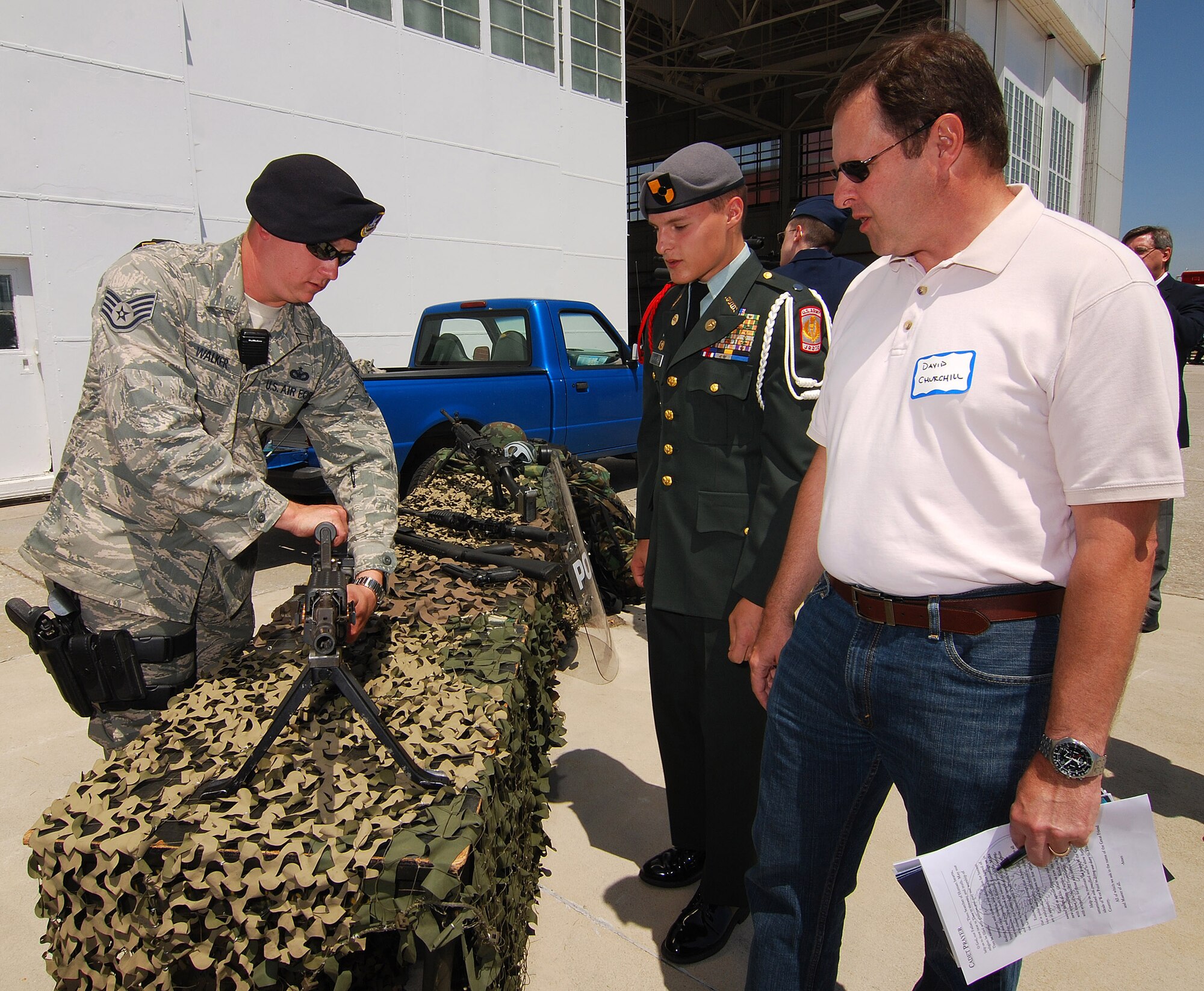 Staff Sgt. Sean Walker, 94th Security Forces Squadron, talks with students and parents about the Air Force small arms on display for Academy Day 2011 at Dobbins ARB, May 7.  (U.S. Air Force photo/ Brad Fallin)