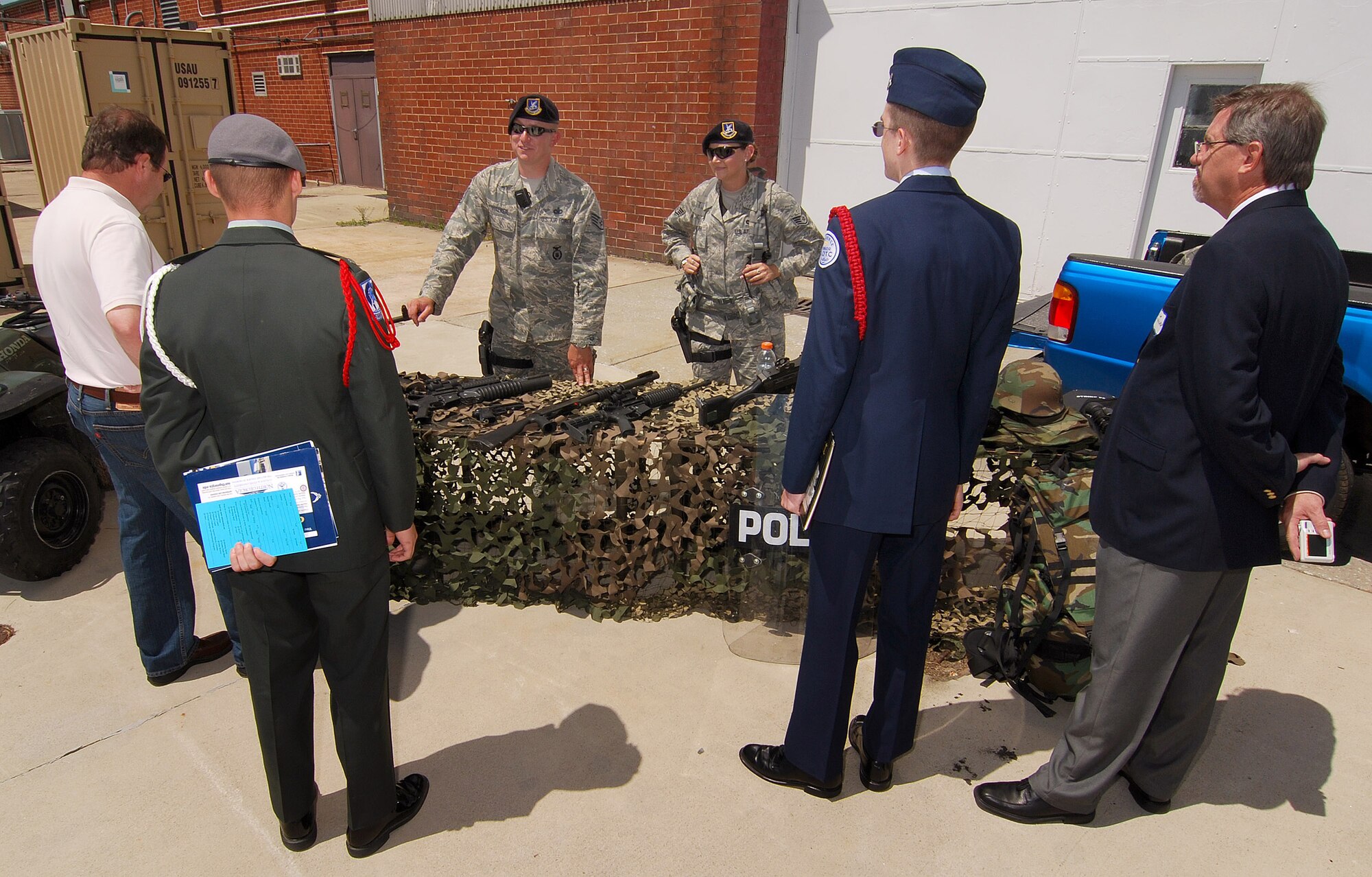 Staff Sgt. Sean Walker and Staff Sgt. Juanita Dahmen, 94th Security Forces Squadron, answer questions about the small arms they have on display for Academy Day 2011 at Dobbins ARB, May 7.  (U.S. Air Force photo/ Brad Fallin)