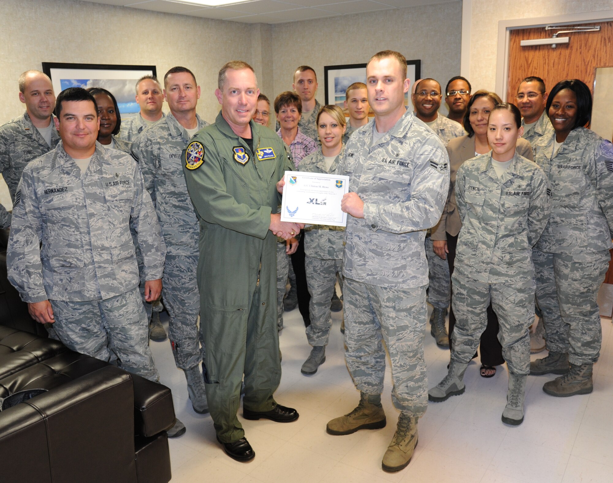 LAUGHLIN AIR FORCE BASE, Texas – Airman 1st Class Clinton Howe, 47th Medical Support Squadron, poses with Col. Michael Frankel, 47th Flying Training Wing commander, Chief Master Sgt. Ray DeVite, 47th FTW command chief, and fellow members of his squadron after being presented the XLer of the Week award here May 4. The XLer is a weekly award chosen by wing leadership and given to those who consistently make outstanding contributions to Laughlin and their unit. (U.S. Air Force photo by Airman 1st Class Blake Mize)