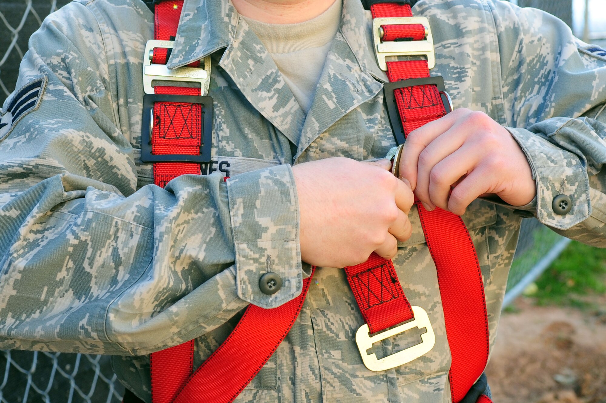 Senior Airman John Hines, 2nd Communications Squadron, secures his safety harness prior to ascending the new communications tower on Barksdale Air Force Base, La., May 6. Capt. Lorenz administered the Oath of Enlistment to Airman Hines at 149 feet as part of a reenlistment ceremony. (U.S. Air Force photo/Senior Airman Joanna M. Kresge)