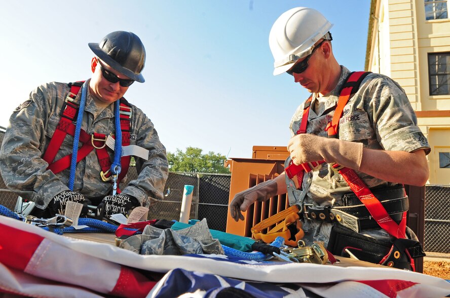 Senior Airman John Hines and Capt. Keith Lorenz, both from 2nd Communications Squadron, prepare their climbing equipment prior to ascending the new communications tower on Barksdale Air Force Base, La., May 6. Captain Lorenz administered the Oath of Enlistment to Airman Hines at 149 feet as part of a reenlistment ceremony. (U.S. Air Force photo/Senior Airman Joanna M. Kresge)