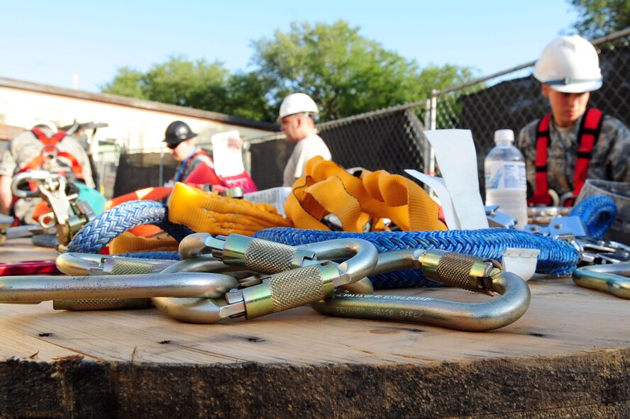 Members of the 2nd Communications Squadron cable maintenance shop prepare to ascend the communications tower located on Barksdale Air Force Base, La., May 6. Capt. Keith Lorenz administered the Oath of Enlistment to Senior Airman John Hines at 149 feet as part of a reenlistment ceremony. (U.S. Air Force photo/Senior Airman Joanna M. Kresge)