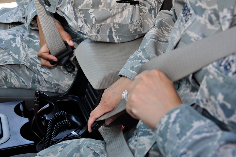 Hurlburt Airmen buckle up for safety before driving to base, May 11, 2011, Fort Walton Beach, Fla. According to the National Highway Traffic Safety Adminstration, seat belt use is one of the most effective ways to protect yourself in a car crash. (U.S. Air Force photo by Staff Sgt. Sarah Martinez/RELEASED)