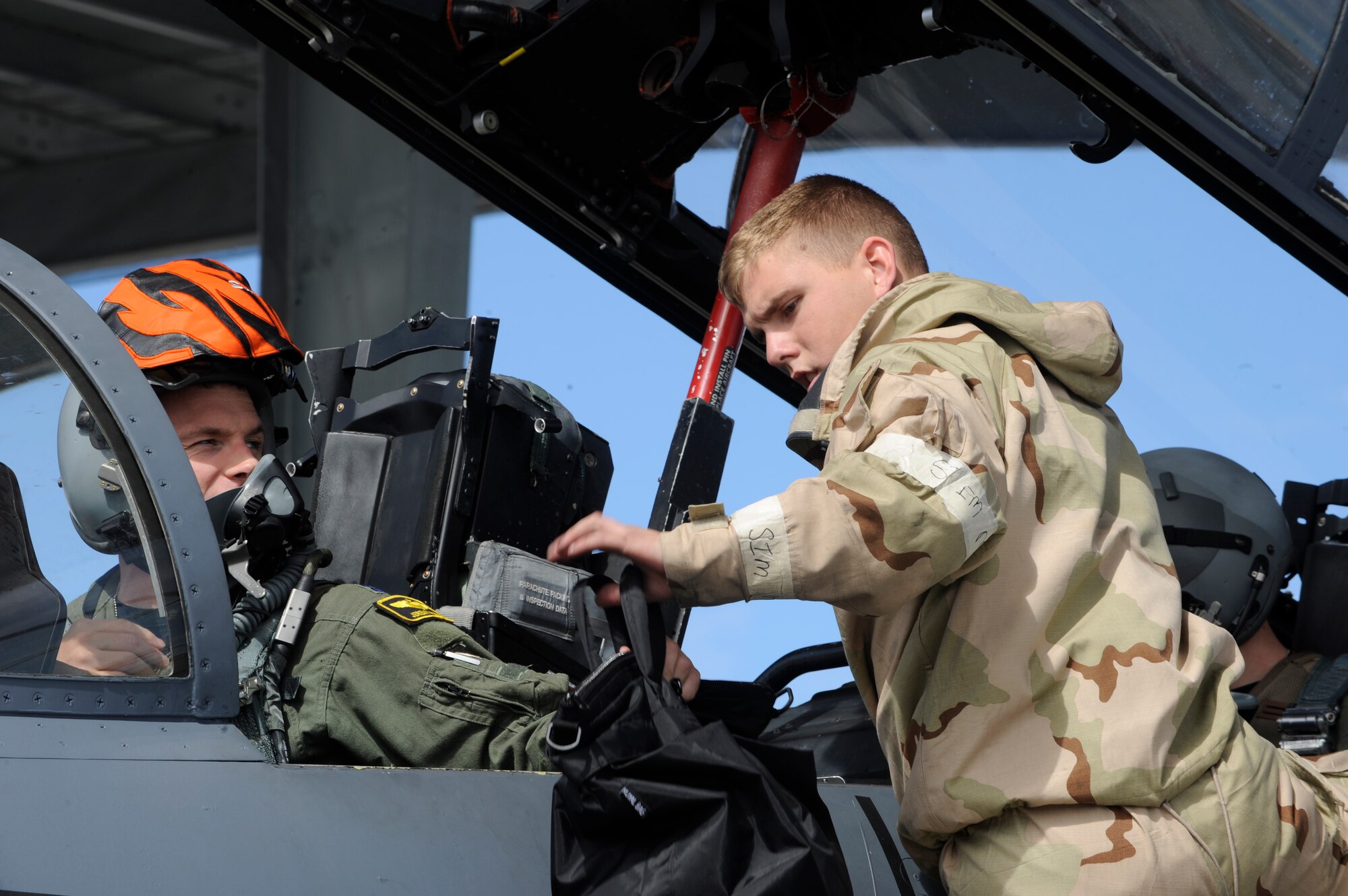 MOUNTAIN HOME AIR FORCE BASE, Idaho – Airman 1st Class James Black, 366th Aircraft Maintenance Squadron, prepares Captain Jeremy Putman, 391st Fighter Squadron, for his flight May 10. Flights proceeded as usual with the exception of the each Airman wearing their Mission Oriented Protective Posture gear as part of the Phase II Operational Readiness Exercise. (U.S. Air Force photo by Senior Airman Angelina Drake)