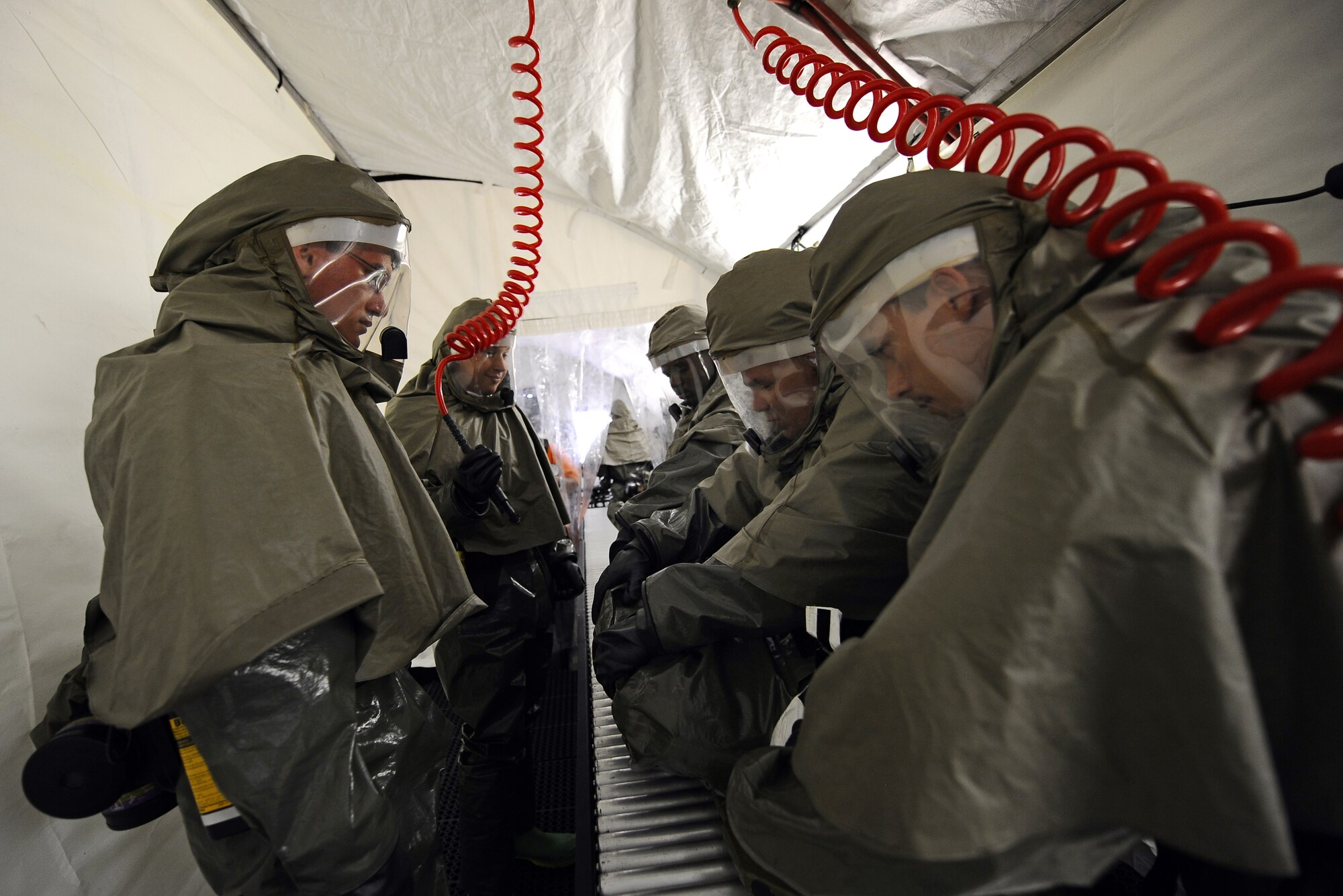 OFFUTT AIR FORCE BASE, Neb.- 55th Medical Group Airmen move a simulated contaminated patient through the ambulatory line inside of the decontamination tent located at the McCoy Hall parking lot, here, May 10. Frequent training ensures the medical professionals are capable of moving people efficiently through the decontamination tent.  The ambulatory line is a section of the DECON tent where immobilized patients are pushed though the rollers while laying on a stretcher.
U.S. Air Force Photo by Josh Plueger (released)

