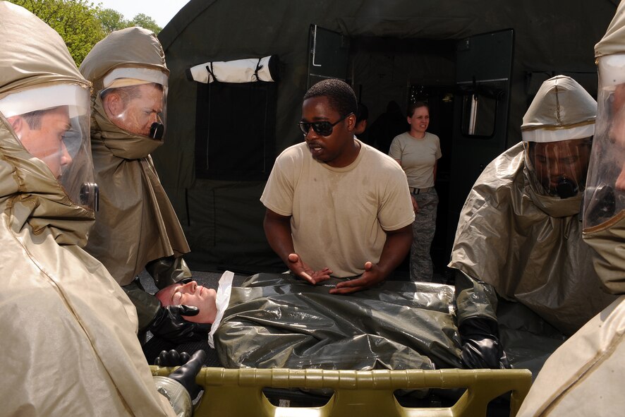 OFFUTT AIR FORCE BASE, Neb. - Staff Sgt. Howard Lance with the 55th Medical Group, briefs colleagues as they begin decontamination training in McCoy Hall parking lot here May 10.  Frequent  training ensures the medical professionals are capable of moving people efficiently through the decontamination tent. Nineteen decontamination-trained Airmen are capable of moving 30 individuals through the tent in a real world situation. U.S. Air Force Photo by Josh Plueger (released)
