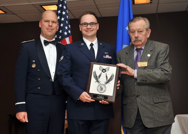 Senior Airman Clinton R. Pettey, 341st Comptroller Squadron, center, receives the Academic Achievement Award at the Airman Leadership School Class 11-E graduation banquet.  Shown presenting the award are Colonel Stephen L. Davis, 341st Missile Wing vice commander, and Mr. Jim Thul, representing the Montana Retiree Association.  The Academic Achievement Award denotes excellence as a scholar and is presented to the student with the highest academic standing, excluding the John L. Levitow Award recipient.  The graduation banquet was held May 3, 2011 in the Grizzly Bend Club at Malmstrom AFB, Mont.  (U.S. Air Force photo / John Turner)