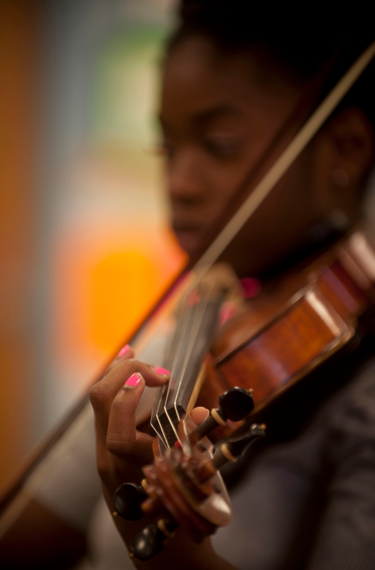 Jovan DeShong, Valdosta State University music education major, shows children at the Child Development Center the different sounds made on the violin by pressing different strings and moving the bow May 9 at Moody Air Force Base, Ga. In speaking on the opportunity, Ms. DeShong said teaching music was her passion and she hoped to make an impact with the children by giving them something to use in the future. (U.S. Air Force photo/ Airman 1st Class Joshua Green)(RELEASED)
