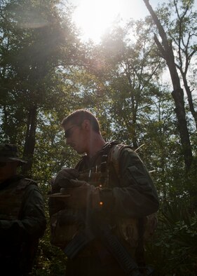 Master Sgt. Randy VanHorn, 41st Rescue Squadron flight engineer, uses only a compass to navigate through a forest during evasion training with his fellow team members May 10 at Moody Air Force Base, Ga. This portion of the training required them to navigate and evade until they linked up with pararescuemen for evacuation. (U.S. Air Force photo/Airman 1st Class Nicholas Benroth)(RELEASED)
