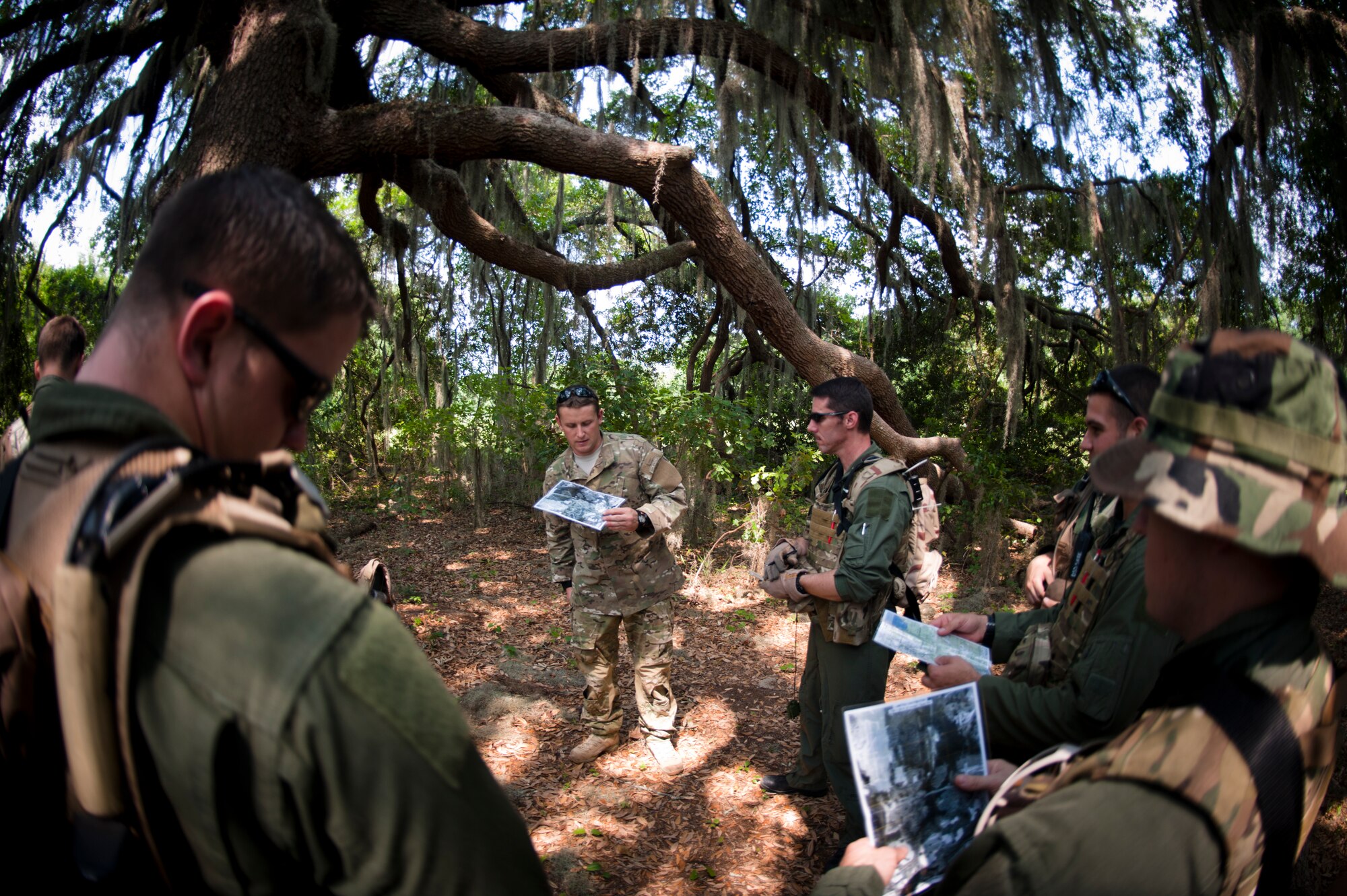 Members of the 347th Rescue Group prepare to navigate the evasion portion of their survival, evasion, resistance and escape refresher training May 10 at Moody Air Force Base, Ga. The participants practiced land navigation and evasion techniques to prepare in the event of a real life scenario. (U.S. Air Force photo/Airman 1st Class Nicholas Benroth)(RELEASED)
