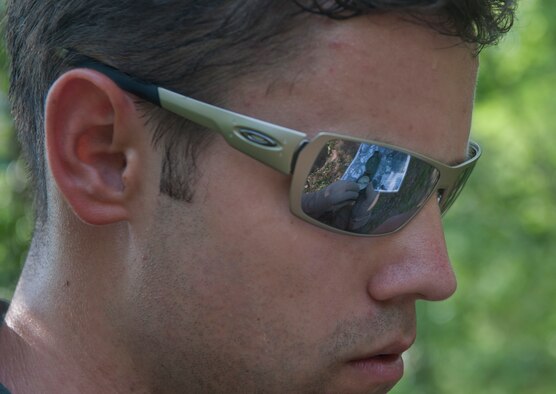 Capt. Nicholas Dhont, 71st Rescue Squadron co-pilot, uses a compass while performing land navigation at Moody Air Force Base, Ga., May 10. The compass, along with a map, helped to keep Captain Dhont on the right path toward his predetermined destination. (U.S. Air Force photo/Airman 1st Class Douglas Ellis)(RELEASED)
