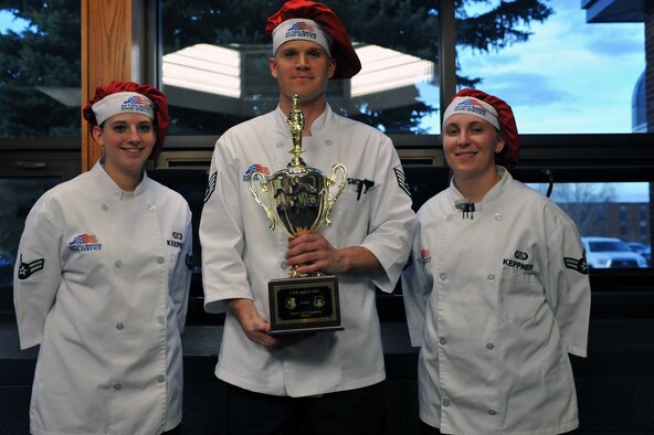 MINOT AIR FORCE BASE, N.D. -- Airman 1st Class Marki Keepers, Staff Sgt. Brandon Smith and Airman 1st Class Kelsey Keppner, chefs from the 5th Force Support Squadron, pose with the trophy after winning the Warrior Chef competition here May 11. This competition pitted the best chefs from the 91st Missile Wing and the 5th Bomb Wing against each other to see which unit had the best chefs on base. (U.S. Air Force photo/Staff Sgt. Keith Ballard) 