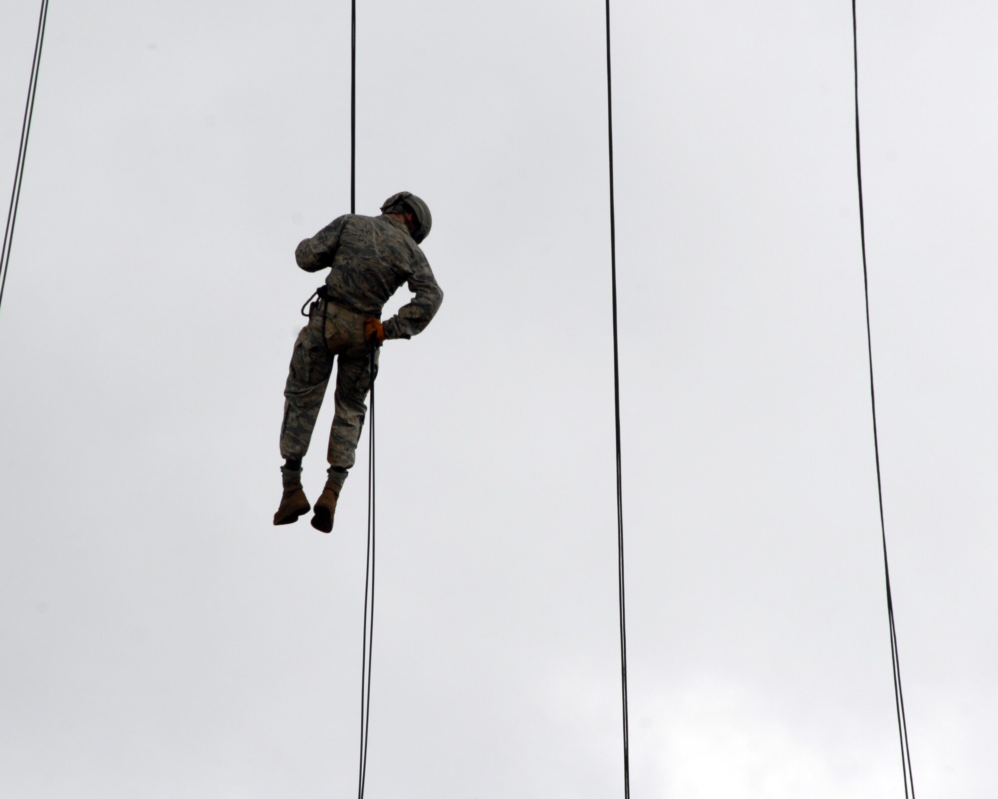 U.S. Air Force Senior Airman Jordan Miller rappels out of a UH-60 Blackhawk in Wahiawa, Hawaii, May 10. He and four other Pacific Air Forces 647th Security Forces Squadron Airmen were chosen to participate with 309 Soldiers in an 11-day Army Air Assault course April 30 to May 11, 2011. (U.S. Air Force photo/Staff Sgt. Carolyn Herrick)