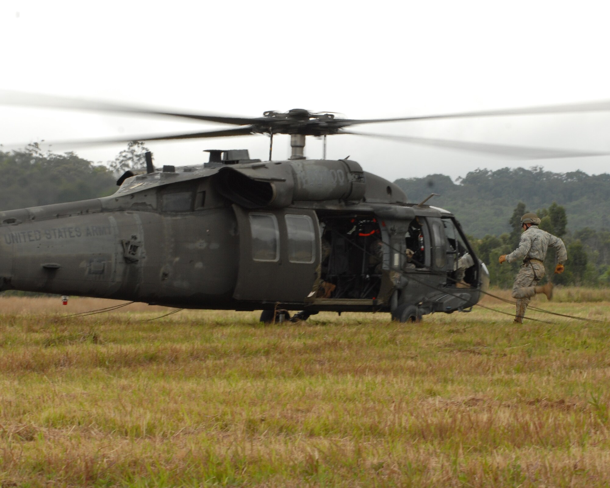 U.S. Air Force Staff Sgt. Shawn Cecere runs to a UH-60 Blackhawk during rappel training in Wahiawa, Hawaii, May 10. He and four other Pacific Air Forces 647th Security Forces Squadron Airmen were chosen to participate with 309 Soldiers in an 11-day Army Air Assault course April 30 to May 11, 2011. (U.S. Air Force photo/Staff Sgt. Carolyn Herrick)