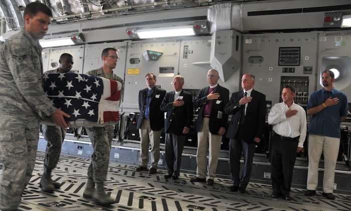 Six clergy from the local community pay their respects to the flag during a dignified transfer demonstration by the Joint Base Charleston Honor Guard May 10, at Joint Base Charleston – Air Base. The clergy were participating in Clergy Appreciation Day to learn what it is like to be a military Chaplain. (U.S. Air Force photo /Airman 1st Class Jared Trimarchi)