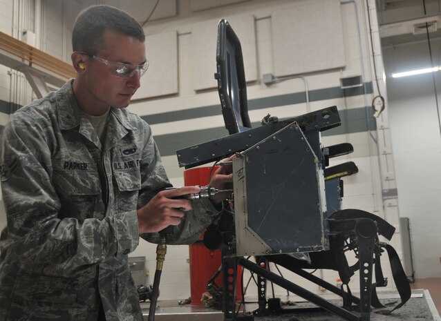 Airman 1st Class Mitchell Parker, an aircraft structural maintenance journeyman from the 437th Maintenance Squadron, drills a whole through a metal plate to repair the seat of a C-17 May 10, on Joint Base Charleston – Air Base. 
 
