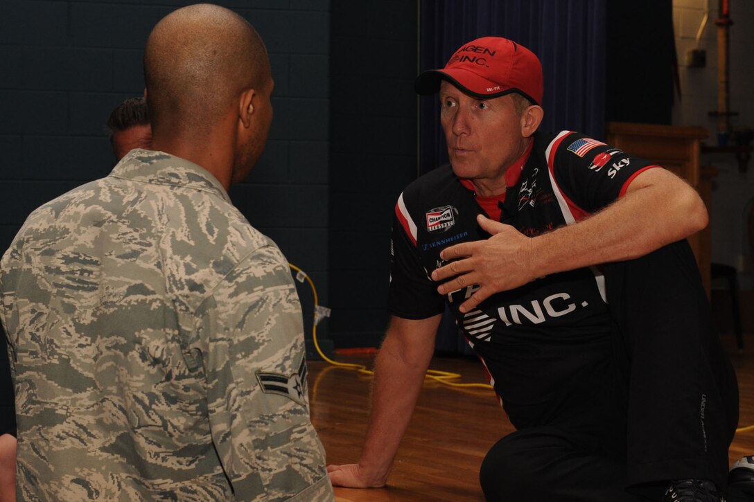 Greg Poe, pilot and motivational speaker, chats with an Airman following his “Elevate Your Life” presentation at the base theater at Langley Air Force Base, Va., May 11, 2011. Poe will perform at AirPower over Hampton Roads May 13-15 with an aerial acrobatics demonstration in his ethanol-powered Fagen MX-2 aircraft. (U.S. Air Force photo by Airman 1st Class Racheal Watson/RELEASED)