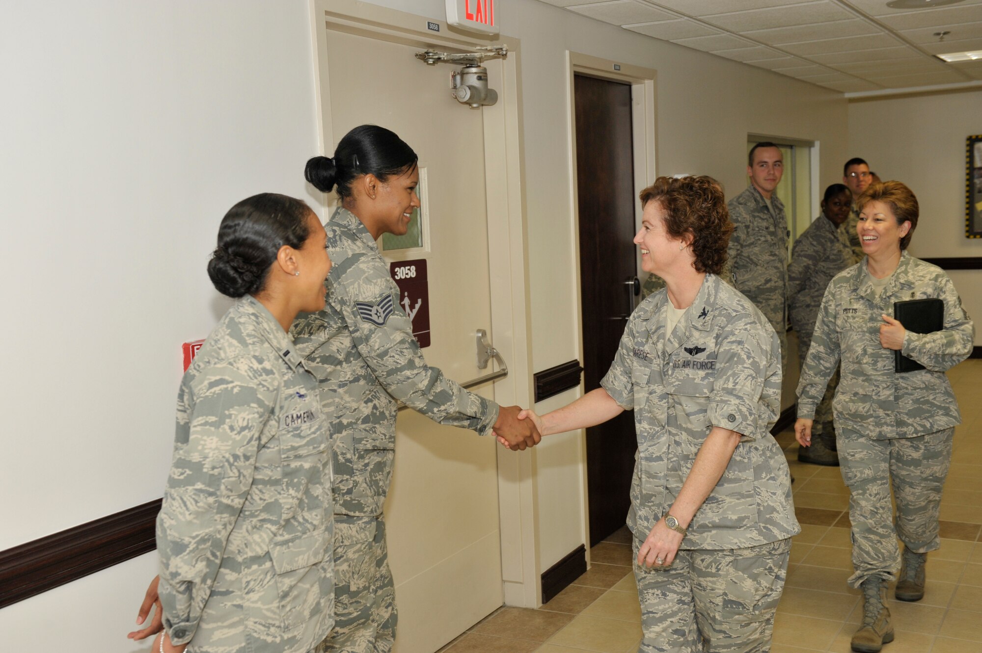Colonel Margaret Matarese, Air Education and Training Command surgeon general, greets Staff Sgt. Shirley John, 325th Medical Support Squadron, expeditionary medical operations team member. Col. Matarese and Chief Master Sgt. Marie Potts, AETC chief of the medical enlisted force, visited the 325th Medical Group recently as part of the AETC SG site visit program. During their three-day visit, Colonel Matarese and Chief Potts held an Enlisted Call to inform Airmen of various topics in the medical force currently under focus by AETC. Additionally, Colonel Matarese coined five 325th MDG Airmen for their hard work and dedication in their career field. The 325th MDG also was recently awarded an excellent rating from the 2011 Air Force Inspector General inspection team, and was awarded a full three-year accreditation, the highest rating possible, from the Accreditation Association for Ambulatory Health Care. “Our Airmen and civilians have done an outstanding job and we are pleased to demonstrate that to Colonel Matarese and Chief Potts,” said Col. Paul Skala, 325th Medical Group commander. (U.S. Air Force photos by Jonathan Gibson)
