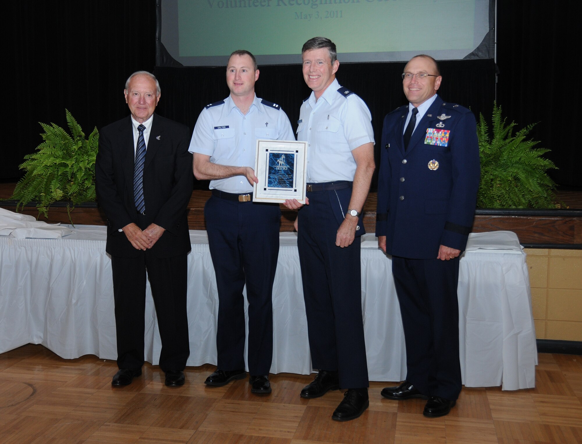 From left, Biloxi Mayor A.J. Holloway, Chaplain (Capt.) Garrell Calton, Chaplain (Lt. Col.) Henry Close III and Brig. Gen. Andrew Mueller, 81st Training Wing commander, are shown at Biloxi's 28th annual Volunteer Recognition Awards ceremony at the Biloxi Community Center.  The two Keesler chaplains accepted the award for Top Adult Volunteer Group on behalf of the Fishbowl Student Ministry Center white rope program.   (U.S. Air Force photo by Kemberly Groue)
