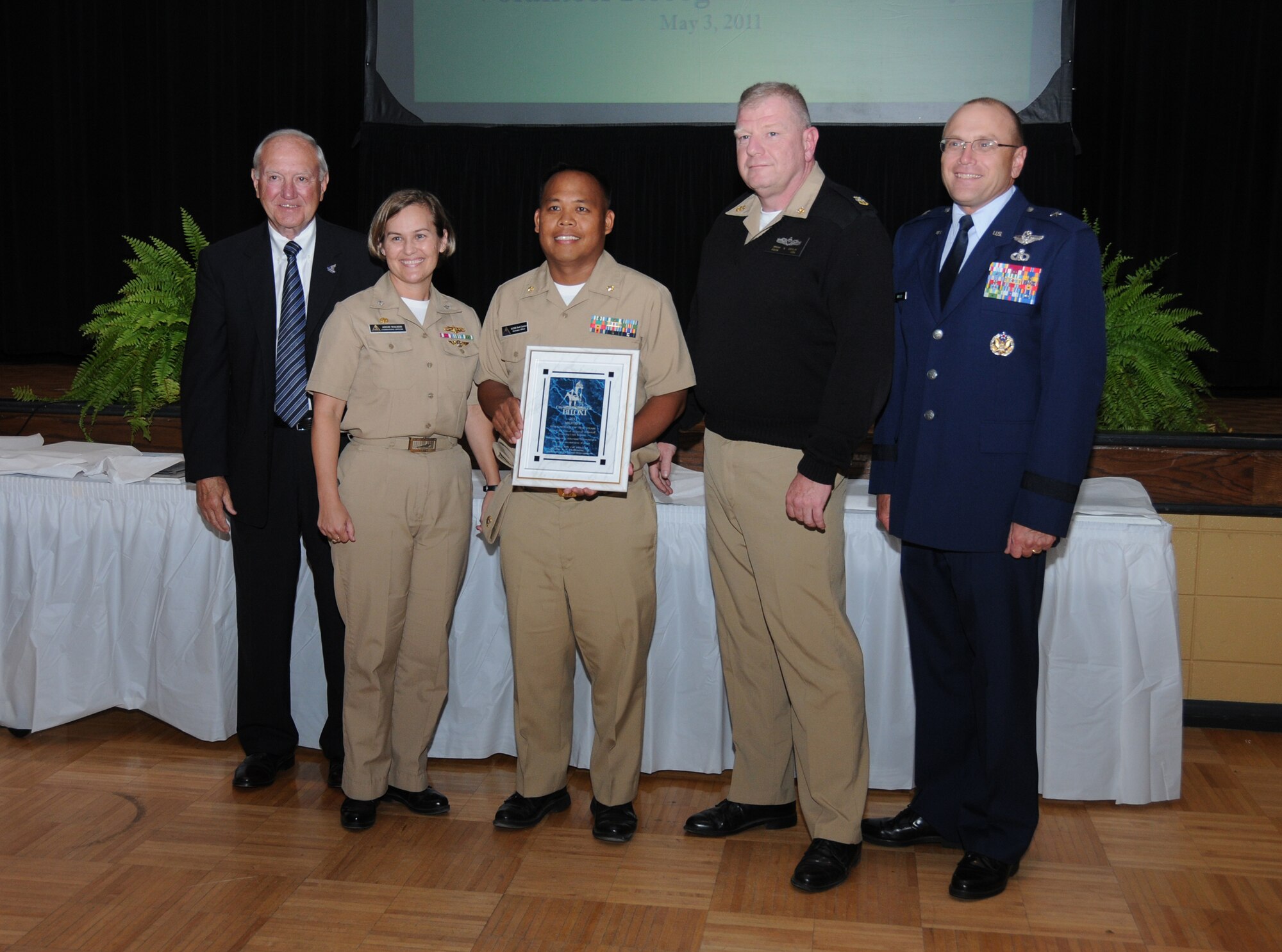 A.J. Holloway, Cmdr. Angie Walker, Lt. Cmdr. Sad Scarino, Fire Controlman Master Chief Brian Devlin and Brig. Gen. Andrew Mueller are shown at Biloxi's 28th annual Volunteer Recognition Awards ceremony at the Biloxi Community Center.  Keesler's Center for Naval Aviation Technical Training Unit was named the city's Military Volunteer of the Year.  Mr. Holloway is mayor of Biloxi, Cmdr. Walker is CNATTU's commanding officer, Lt. Cmdr. Carino is CNATTU's executive officer, Chief Devlin is CNATTU's command chief and General Mueller is the 81st Training Wing ommander.   (U.S. Air Force photo by Kemberly Groue)