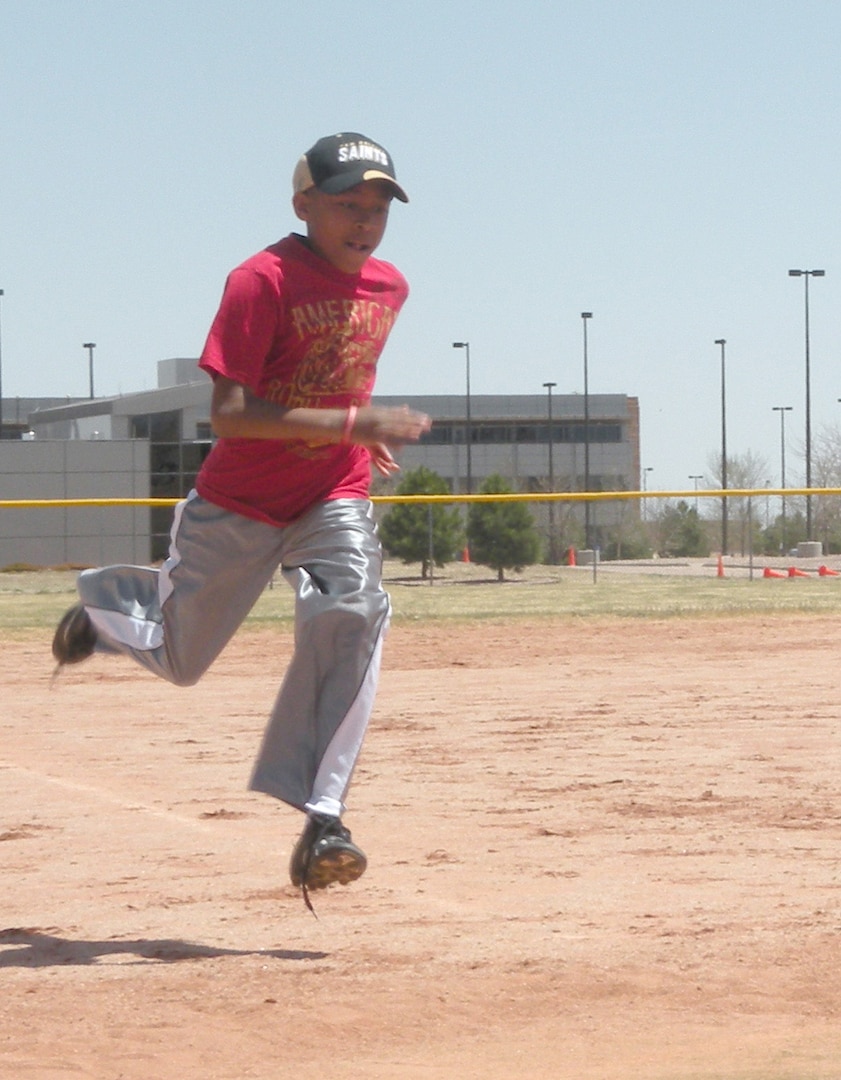 SCHRIEVER AIR FORCE BASE, Colo. -- Vincent Fischer, son of Lt. Col. Vincent Fischer, 50th Security Forces Squadron, runs to home plate during the Aquafina Major League Baseball Pitch, Hit and Run competition May 7 at the Schriever base softball field. "Awesome event for Schriever affiliated kids," Colonel Fischer said. "Thanks for putting on a great event. It was very professional and organized for the kids and parents." (Courtesy photo)                             