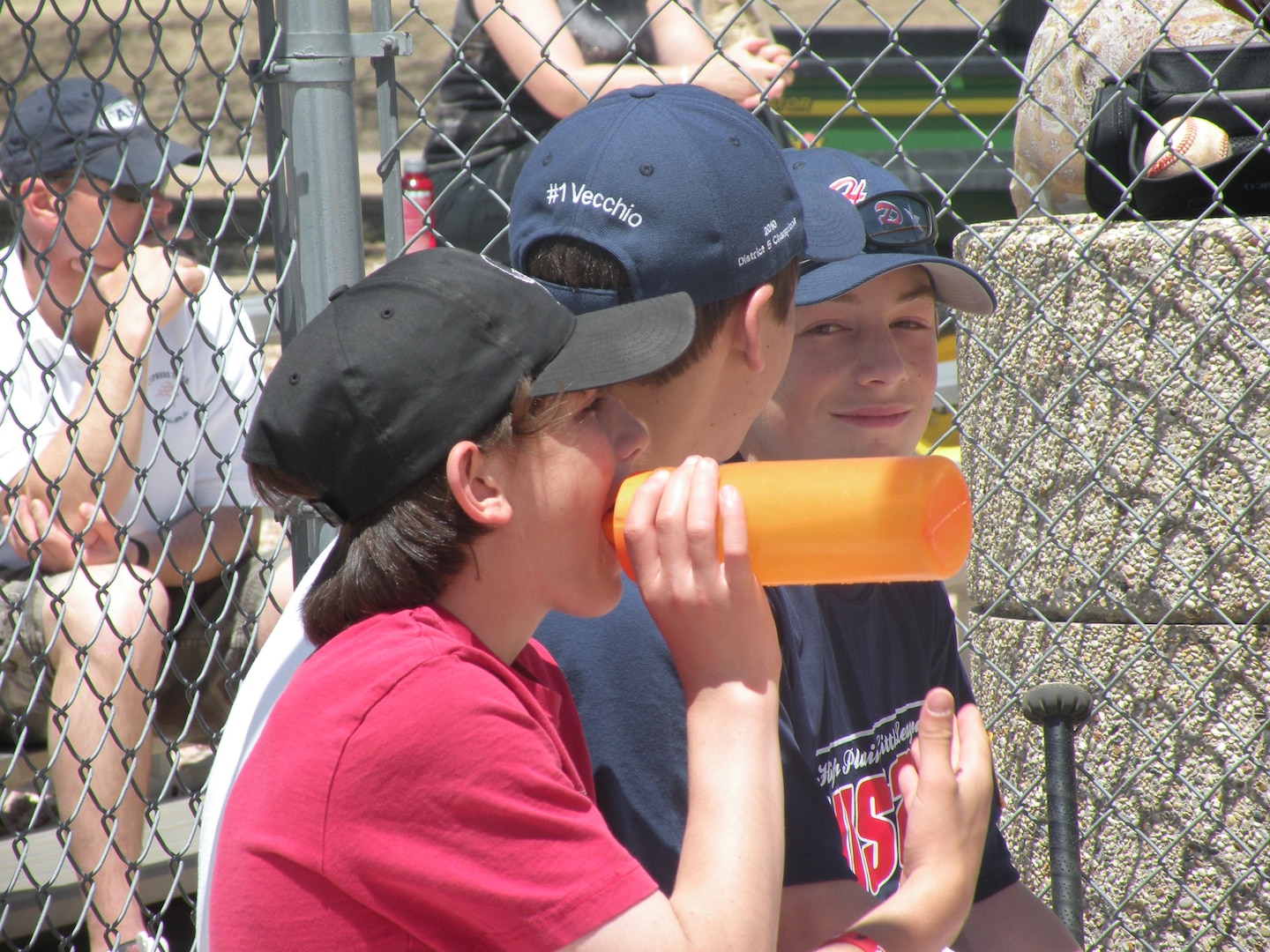 SCHRIEVER AIR FORCE BASE, Colo. -- Anthony Wentz, Sean Vecchio and Matt Wentz, sons of Lockheed Martin contractor Matt Wentz take a break prior to competing in the Aquafina Major League Baseball Pitch, Hit and Run competition May 7 at the Schriever base softball field. "Awesome event for Schriever affiliated kids," Colonel Fischer said. "Thanks for putting on a great event. It was very professional and organized for the kids and parents."  (Courtesy photo)                                