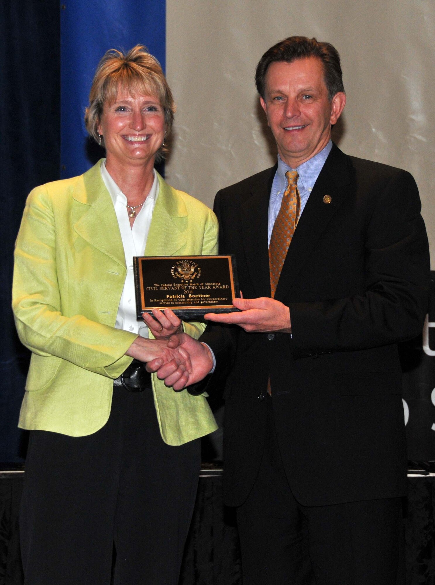 Patricia Boettner accepts her 934th Airlift Wing Civil Servant of the Year award in the professional category at the Civil Service Awards Ceremony May 6. (Air Force Photo/Paul Zadach)