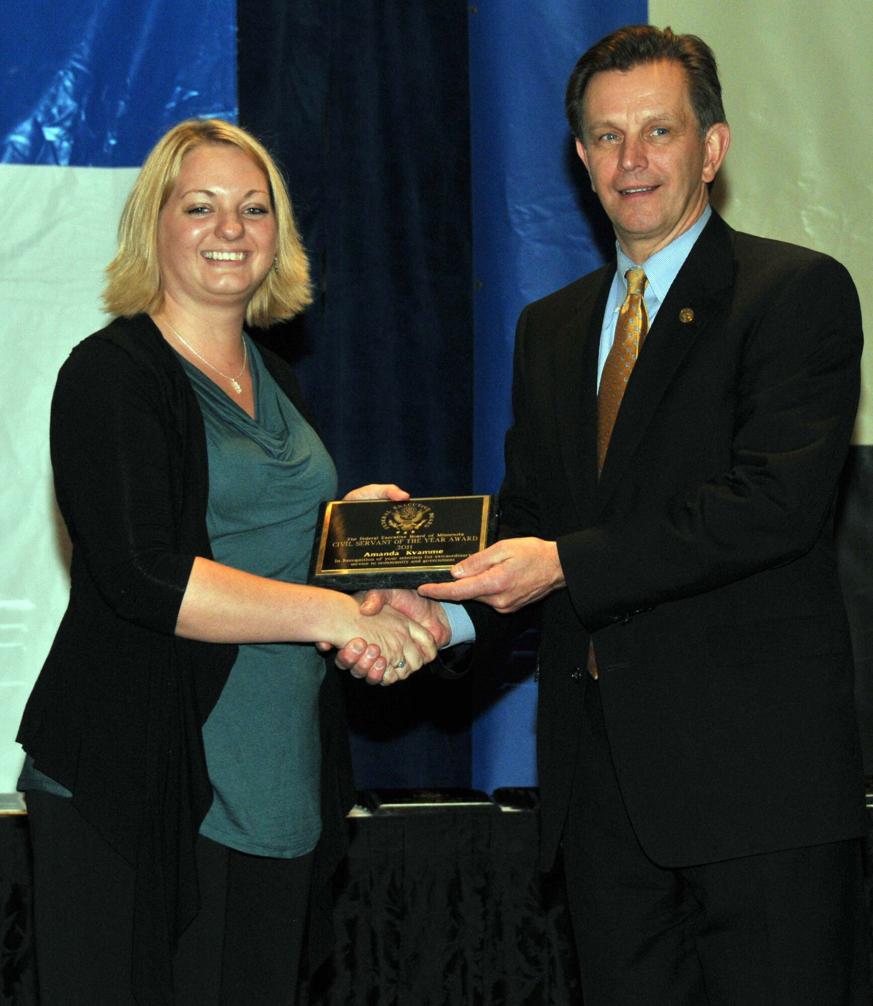 Amanda Millsap accepts her 934th Airlift Wing Civil Servant of the Year award in the administrative category at the Civil Service Awards Ceremony May 6. (Air Force Photo/Paul Zadach)