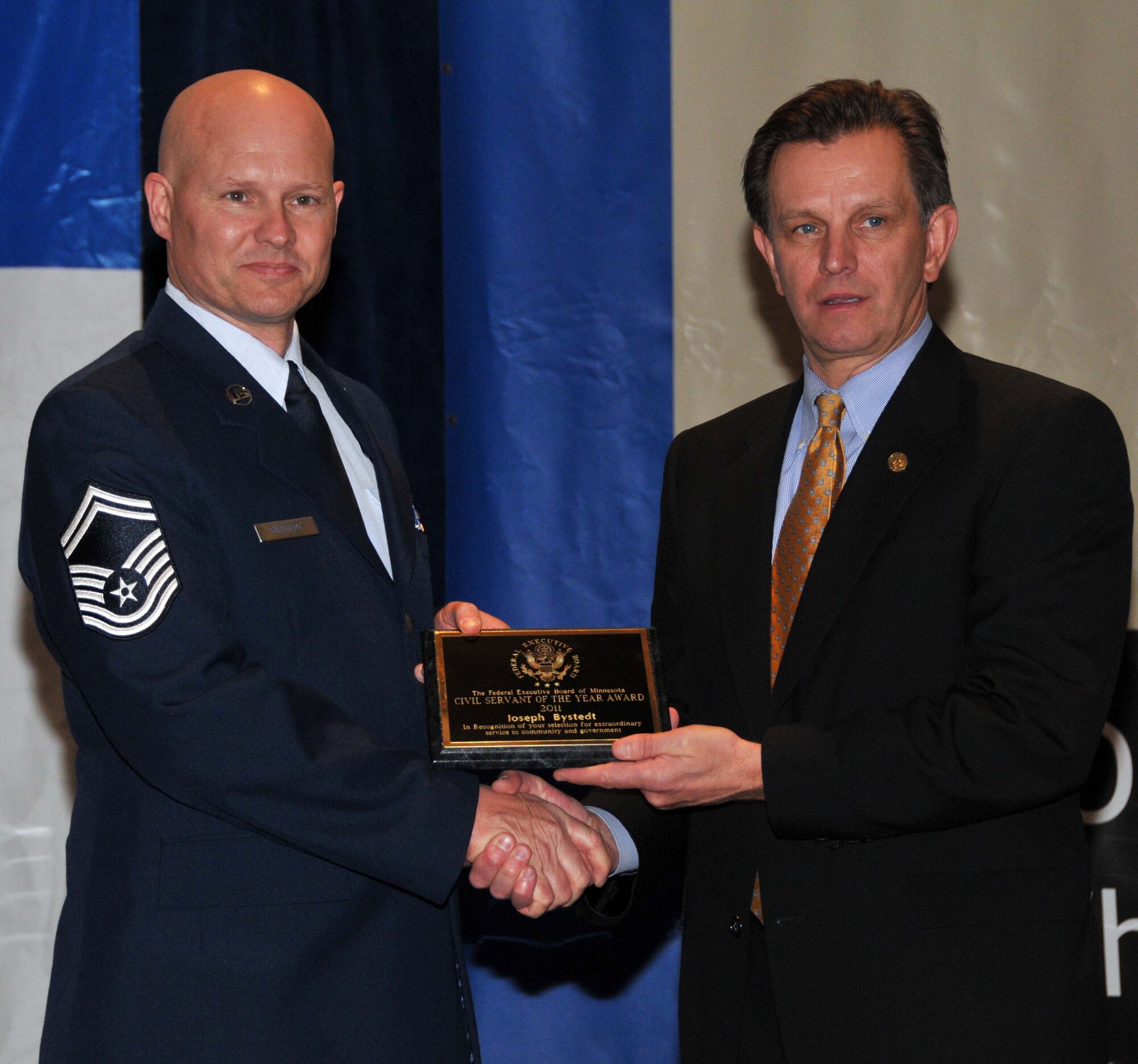 Senior Master Sgt. Joe Bystedt accepts his 934th Airlift Wing Civil Servant of the Year award in the skilled trades category at the Civil Service Awards Ceremony May 6. (Air Force Photo/Paul Zadach)