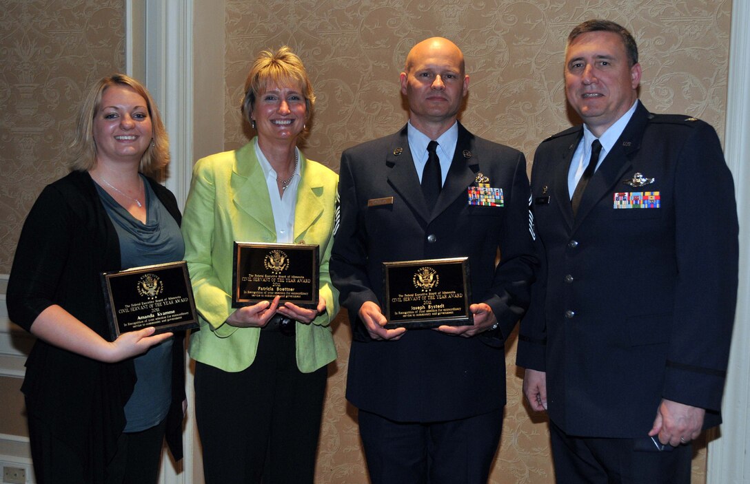 From left, 934th Airlift Wing Civil Servants of the Year Amanda Millsap, Patricia Boettner and Joseph Bystedt stand with Col. Darrell G. Young, 934th Airlift Wing commander, at the awards ceremony May 6. (Air Force Photo/Paul Zadach)