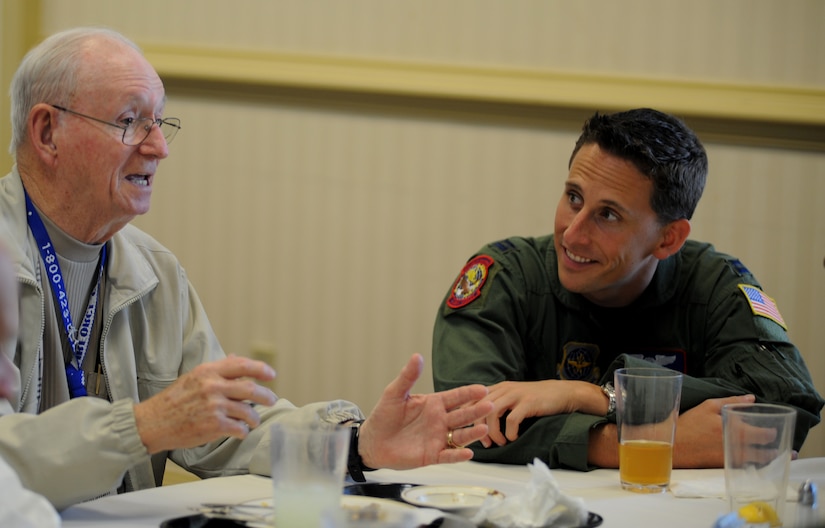 Don Marshall shares one of his World War II stories with Capt.John McDaniel during lunch at the Charleston Club on Joint Base Charleston, May 5. Mr. Marshall  was attending the World War II Hump pilots reunion. The Hump pilots have been meeting annually since 1946. Captain McDaniel is from the 15th Airlift Squadron.  (U.S. Air Force photo/ Staff Sgt. Nicole Mickle)  