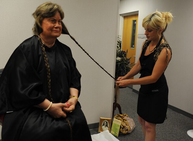 June Griggs gets her hair braided by a volunteer sylist at the Military Spouses' Appreciation Tea, on Joint Base Charleston, May 7.  Ms. Griggs has been growing her hair without having it cut for 30 years. She decided to donate her hair to Pantene Beautiful Lengths in honor of her daughter who passed away from Lukemia. Pantene Beautiful Lengths makes wigs for cancer patients. Ms. Griggs has been volunteering on Joint Base Charleston for 45 years.  (U.S. Air Force photo/ Staff Sgt. Nicole Mickle) released  