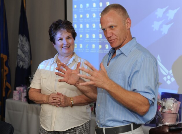 Linda Lankosz listens as Terry Serpico tells a story about his father to a captive audience at the Military Spouses' Appreciation Tea on Joint Base Charleston, May 7. Mr. Serpico plays the character Col. Frank Sherwood on the television series Army Wives. He volunteered to talk and take pictures with the military spouses during the event. The Tea was sponsored by the Airmen and Family Readiness Center to show appreciation for the military spouses.  Some of the activities included gift giveaways, crafts, and make-overs given by professional salon volunteers. Mrs. Lankosz is a community readiness consultant at the Airmen and Family Readiness Center.  (U.S. Air Force photo/ Staff Sgt. Nicole Mickle)  