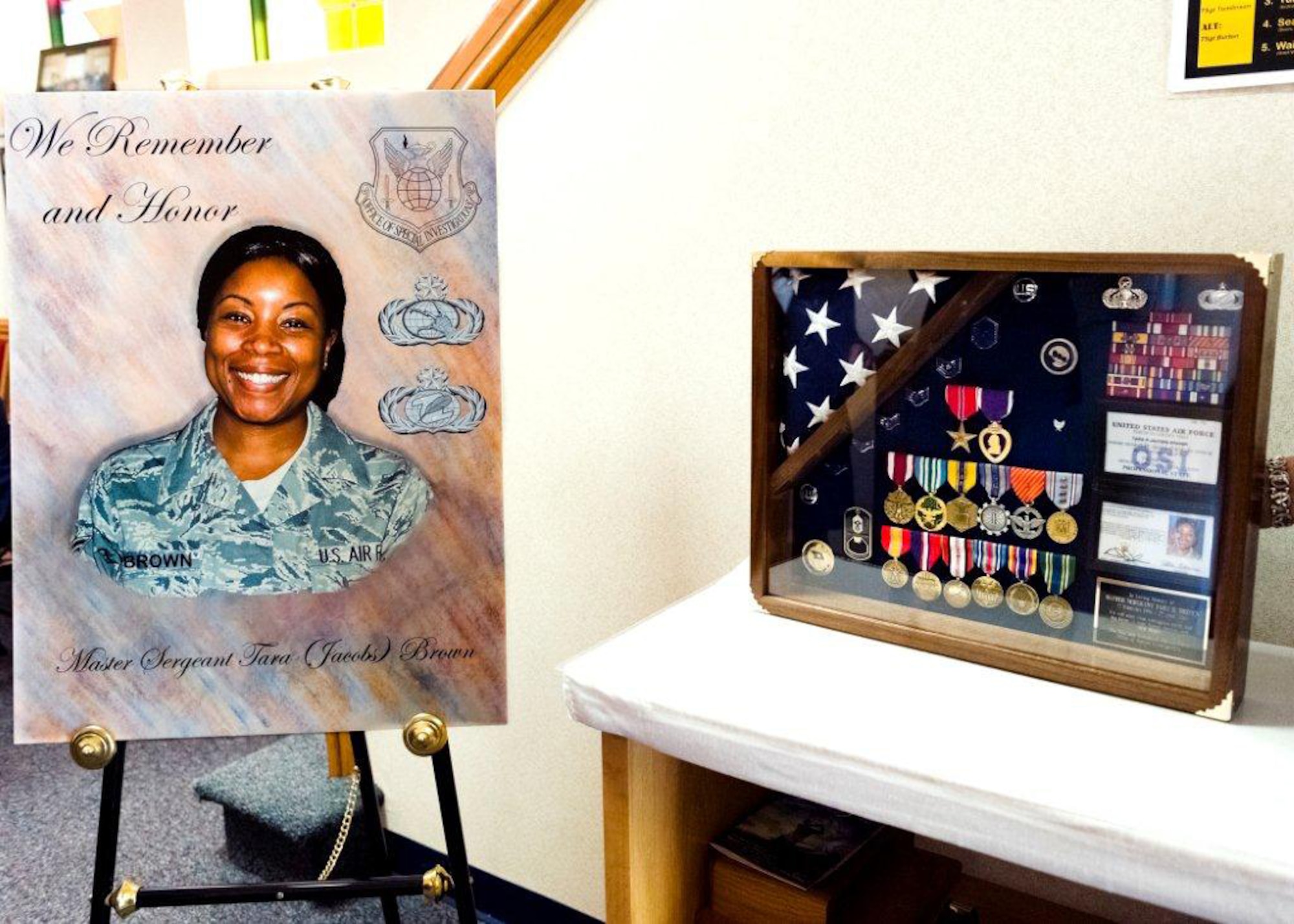 A display set up at Master Sgt. Tara Brown's memorial service included her picture and a shadow box containing her AFOSI staff credentials and military decorations. Her memorial service was held May 9 at Joint Base Andrews, Md.. Sergeant Brown was one of nine Americans killed during a shooting April 27 at Kabul International Airport, Afghanistan. (U.S. Air Force Photo by Mike Hastings.)