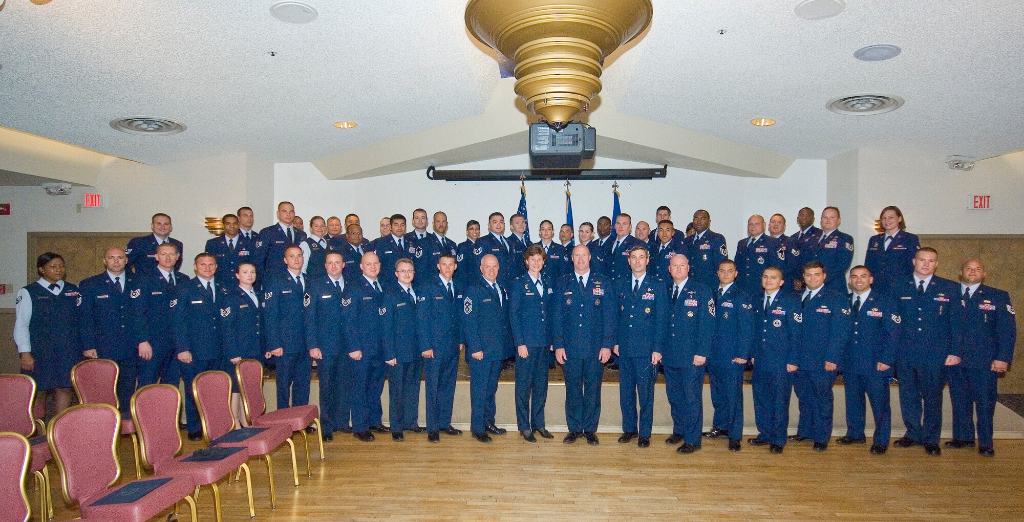 Fifty Edwards Community College of the Air Force graduates pose with base leadership May 5 at Club Muroc. (Air Force photo by Rob Densmore)