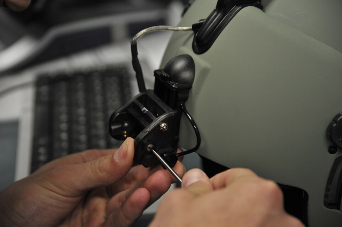 Airman 1st Class Daniel Sotelo, 811th operation support squadron aircrew flight equipment technician, tightens the screws on a night vision goggle mount for a flight helmet, May 10. (U.S. Air Force photo by Senior Airman Perry Aston) (Released)