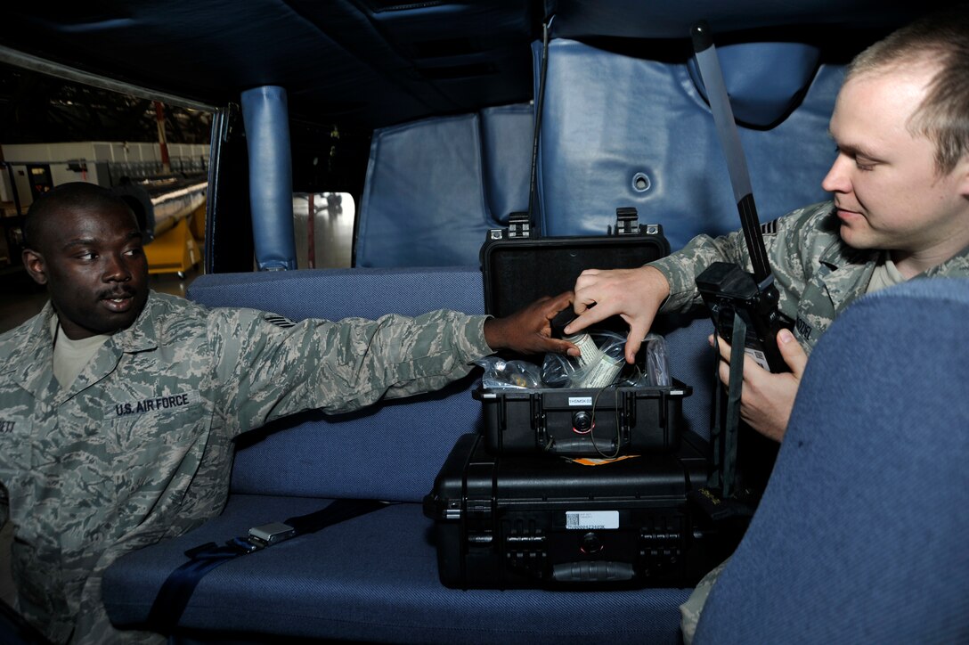 Staff Sgt. Jason Garrett and Staff Sgt. Andrew Kozief, aircrew flight equipment technicians from the 455th Operation Support Squadron, Wright Paterson Air Force Base assigned to 811th OSS, perform a mission termination inspection on survival equipment in a UH-1N Iroquois Helicopter on May 10. The equipment is regularly inspected to ensure all equipment is accounted for. (U.S. Air Force photo by Senior Airman Perry Aston) (Released)