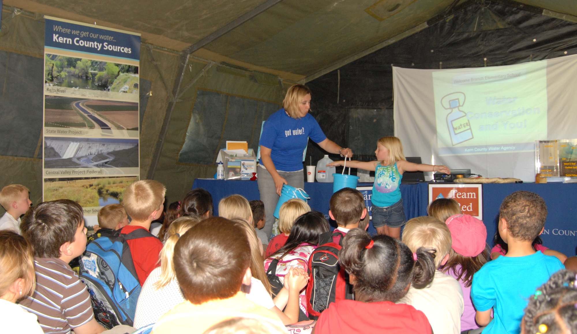 Sarah Clayton, Kern County Water Agency educational consultant, teaches Branch Elementary students about conserving water May 3. She is showing a youngster how many gallons of water are wasted while leaving the faucet running while brushing teeth. The water conservation tent was one of five interactive displays set up at the 3rd Annual Branch Elementary School Science Carnival. (Air Force photo by Kenji Thuloweit)
