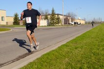 MINOT AIR FORCE BASE, N.D. -- Airman 1st Class Kenny Bradley, 5th Force Support Squadron chef, sprints towards the finish line during a 5K run held at the McAdoo Fitness Center for the Triple Crown event here May 7. Triple Crown event is a three part cardio tournament consisting of a 5K run on May 7, a 10K run on May 14 and a triathlon May 21. (U.S. Air Force photo/ Airman 1st Class Aaron-Forrest Wainwright)